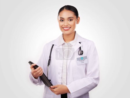 Photo for Happy woman, doctor and portrait with tablet in healthcare research or online advice against a studio background. Female person or medical professional smile with technology for Telehealth on mockup. - Royalty Free Image
