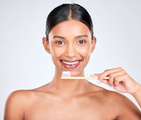 Photo for Toothbrush, toothpaste and dental with woman in portrait, health and fresh breath isolated on white background. Bamboo, face and teeth whitening with oral care, orthodontics and routine in studio. - Royalty Free Image