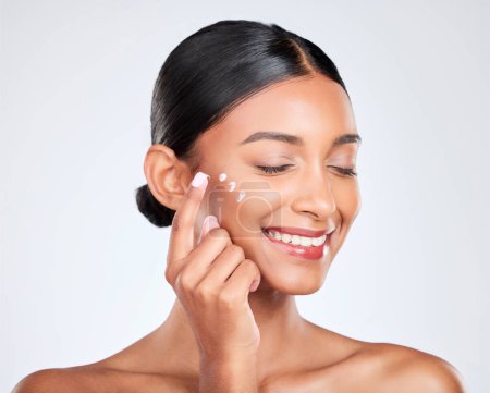 Photo for Cream, skincare and woman with cosmetics, shine and dermatology on a white studio background. Person, smile and model with creme, luxury and healthy skin with beauty, glow or aesthetic with self care. - Royalty Free Image