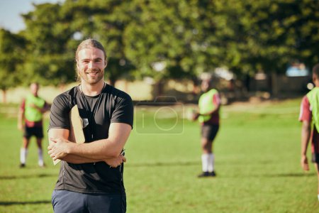 Photo for Portrait, fitness and a rugby coach on a field with his team training or getting ready for match competition. Exercise, sports and strategy with a happy male trainer on grass for practice workout. - Royalty Free Image