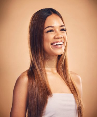 Photo for Face, beauty and hair with a natural woman in studio on a brown background for keratin treatment. Vision, smile and shampoo with a happy young model at the salon for growth or aesthetic haircare. - Royalty Free Image