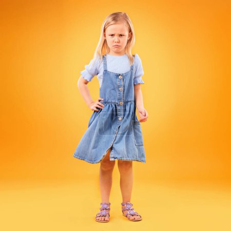 Photo for Sad, portrait and girl child in studio with bad news, feedback or negative review on orange background. Face, frown and kid with emoji disappointed expression, angry or tantrum, reaction or behavior. - Royalty Free Image