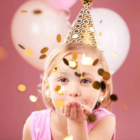Photo for Balloons, birthday and portrait of girl with confetti on pink background for party, celebration and special day. Happy, excited and young child with decoration for magic, wonder and glitter in studio. - Royalty Free Image