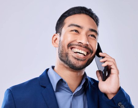 Photo for Business, phone call and man with a smile, conversation and connection on a white studio background. Person, employee and entrepreneur with a smartphone, communication and discussion with a contact. - Royalty Free Image