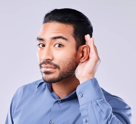 Photo for Hands, ear and portrait of asian man in studio for gossip, listening or speak up sign on grey background. Hearing, secret and face of Japanese guy model with emoji icon for deaf, sign language or huh. - Royalty Free Image