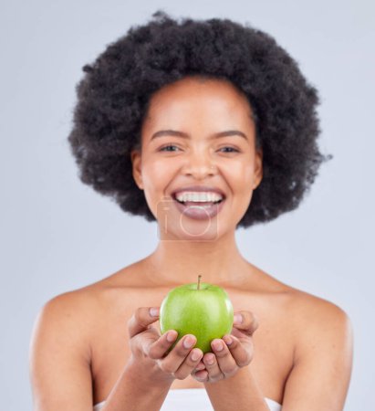 Photo for Apple, black woman and portrait with beauty, diet and natural skincare glow in studio. Happy, face and fruit for healthy nutrition, grey background and wellness with smile from vegan and organic food. - Royalty Free Image