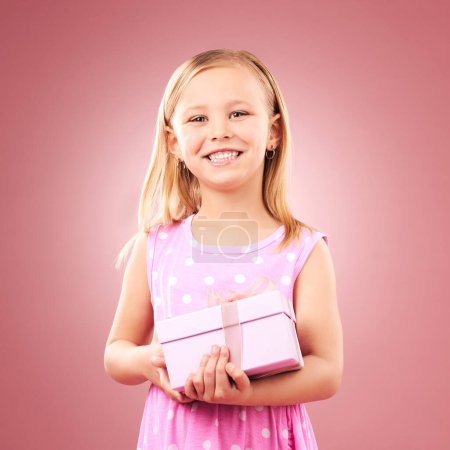 Photo for Child, gift or present portrait in studio for birthday, holiday or happy celebration. Excited girl kid on a pink background with box for surprise, giveaway prize or celebrate win with smile. - Royalty Free Image