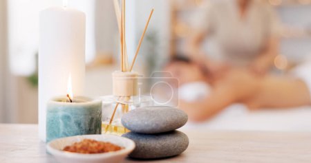 Photo for Spa, rock and candle to relax in a room with atmosphere, mood or ambience in a health club. Wellness, luxury and treatment with still life objects on a table in a clinic for rest and relaxation. - Royalty Free Image