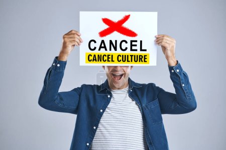 Photo for Cancel culture, man and protest sign in hand with message for social media violence and support in studio. Banner, person and mouth with mockup space for solidarity and opinion on grey background. - Royalty Free Image