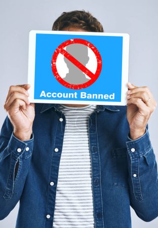Photo for Banned, account and man with a sign for social media, guidelines and rules for online profile and poster in studio background. Internet, ban and person with a banner in hands for virtual exclusion. - Royalty Free Image