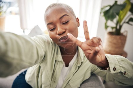 Photo for Woman, face and peace for selfie in home while live streaming vlog, post update or broadcast. Happy african content creator, profile picture or show v sign with hand emoji for social media influencer. - Royalty Free Image