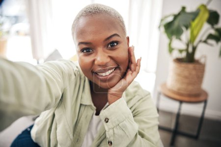 Photo for Home, portrait or black woman taking a selfie with a happy smile on sofa to post on social media. Apartment, face or African person taking a photo, vlog or picture on couch in living room to relax. - Royalty Free Image