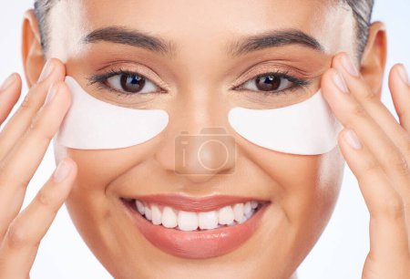 Photo for Skincare, beauty and happy woman with collagen pad for anti aging or skin glow on white background. Cosmetics, facial detox and face of model with solution or eye product for dermatology in studio - Royalty Free Image