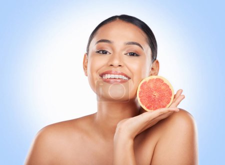 Photo for Beauty skincare, portrait and happy woman with grapefruit treatment results, natural self care or fruit benefits. Vitamin C product, eco friendly cosmetics or studio face of person on blue background. - Royalty Free Image