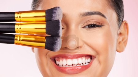 Photo for Face makeup, brush or happy woman with studio cosmetics tools, anti aging glow and closeup facial transformation. Foundation application product, happiness or aesthetic model smile on pink background. - Royalty Free Image