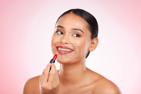 Photo for Lipstick, mockup and face of happy woman with makeup or cosmetics on pink background space and thinking about product. Lips, beauty and model with ideas for skincare or choice of red color on mouth. - Royalty Free Image