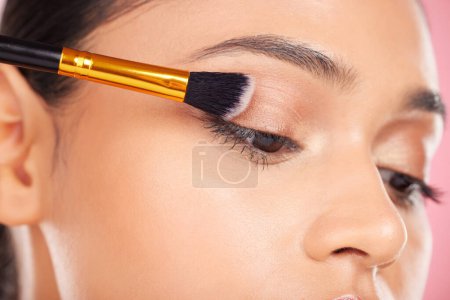 Photo for Woman, eyeshadow and makeup, beauty and brush with transformation and cosmetic product isolated on pink background. Closeup, cosmetology and powder with model, wellness and change in a studio. - Royalty Free Image