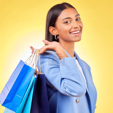 Photo for Shopping, bag and portrait of woman as a customer happy for retail fashion isolated in a studio yellow background. Smile, Product, sale and young person with discount, deal or promo on clothes. - Royalty Free Image