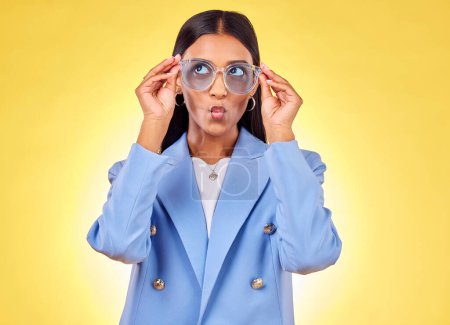 Photo for Funny, happy woman and sunglasses with kiss, comedy and silly face in a studio. Yellow background, pout and young female person with modern fashion, trendy cool style and creative work clothing. - Royalty Free Image