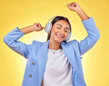 Photo for Dancing, fashion or happy woman streaming music in headphones on yellow background. Relax, smile or calm entrepreneur listening to radio song, album or audio sound on subscription playlist in studio. - Royalty Free Image