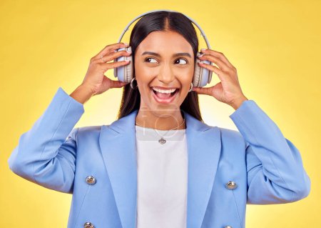 Photo for Headphones, excited or businesswoman streaming music thinking of podcast on yellow background. Happy, smile or entrepreneur listening to radio song or audio sound on subscription playlist in studio. - Royalty Free Image