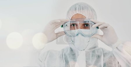 Photo for PPE, person and safety suit goggles of lab worker and healthcare professional in hospital or clinic. Cleaning, bacteria protection and face mask with virus, pharmacy and wellness research with bokeh. - Royalty Free Image