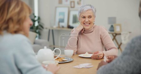 Photo for Tea, happy and retirement with friends and playing cards in living room for relax, diversity and poker. Games, smile and community with group of old people in nursing home for party and celebration. - Royalty Free Image