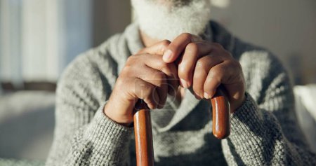 Photo for Closeup, senior and hands of man with cane for support, walking help and aging. Morning, house and elderly person with gear for a walk on the living room sofa for healthcare and holding for strength. - Royalty Free Image