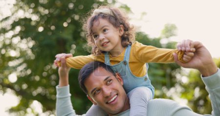 Photo for Happy, piggyback and father with girl in nature, bonding and having fun. Smile, dad and carrying child on shoulders, play and enjoying quality family time together outdoor in park with love and care - Royalty Free Image