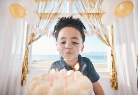 Photo for Birthday, cake and party with child and candles for gift celebration, food and dessert. Excited, balloons and happy with young boy making wish in family home for surprise, flame and holiday event. - Royalty Free Image
