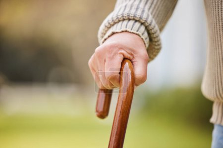 Photo for Walking stick, support and elderly with hands of person with a disability for injury, osteoporosis and medical. Healthcare, retirement and balance with closeup of old man and cane in nursing home. - Royalty Free Image