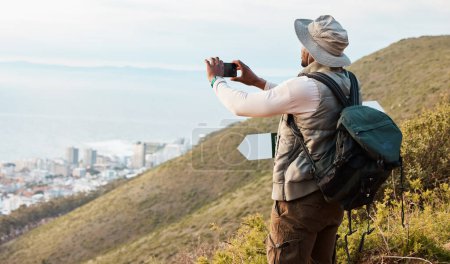 Photo for Phone, hiking and photography of black man in nature, adventure and travel on holiday vacation. Mobile, picture of city and person trekking outdoor, tourist journey and view of countryside landscape. - Royalty Free Image