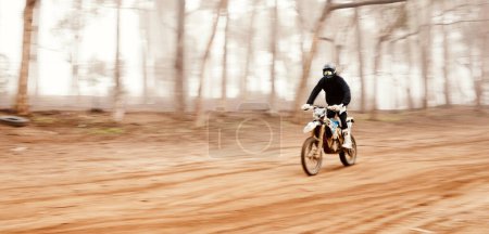 Photo for Motorcycle, speed and space with a sports man in the forest for adrenaline while dirt biking. Bike, training and power with a person driving fast on an off road course for freedom or performance. - Royalty Free Image