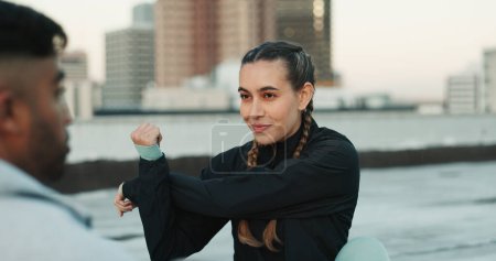 Photo for Fitness, personal trainer and stretching on rooftop in city for exercise, sport or outdoor workout. Woman and man coaching in sports practice, body warmup or cardio together in an urban town. - Royalty Free Image