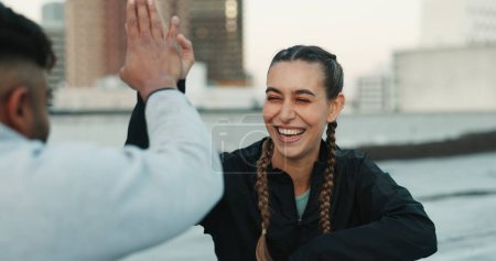 Photo for Happy couple, celebration or high five on rooftop for fitness exercise or workout together with pride or smile. Athletes, motivation or excited or man with woman, support or goal on building in city. - Royalty Free Image