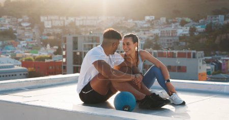 Photo for Fitness, rest and happy couple outdoor for exercise, workout or training together on a city building rooftop. Man and woman on urban break with medicine ball, conversation or health and wellness. - Royalty Free Image