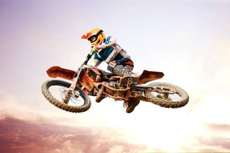 Photo for Sky background, motorcycle and jump for training or sports with fitness, balance or challenge in nature on mock up space. Bike, freedom and adventure for competition and exercise with safety gear. - Royalty Free Image