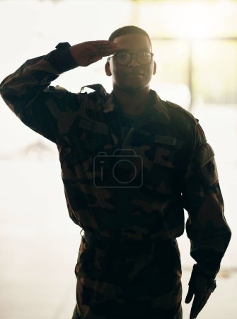 Photo for Confident soldier portrait, army and salute in building with pride, professional hero and night service. Military career, security and courage, black man in camouflage uniform at government agency - Royalty Free Image