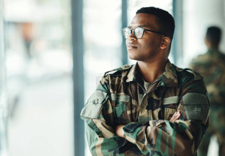 Photo for Confident soldier thinking, mockup and arms crossed in army building, pride and professional hero service. Military career, security and courage, black man in camouflage uniform at government agency - Royalty Free Image