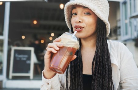 Photo for Woman, smoothie and portrait outdoor at a restaurant and drink from cafe with a smile. Milkshake, coffee shop and gen z fashion of a female person drinking from a straw on break on diner patio. - Royalty Free Image