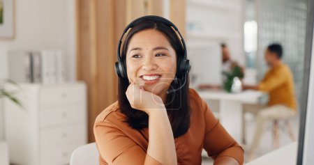 Photo for Call center, woman and thinking with smile in office for CRM questions, FAQ contact and IT support. Happy asian telemarketing agent at computer of sales advisory, telecom solution or consulting ideas. - Royalty Free Image