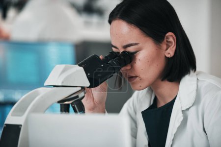 Photo for Science, microscope and Asian woman in laboratory for research, data analysis and study. Biotechnology, healthcare and scientist looking in equipment for medical innovation, sample and DNA testing. - Royalty Free Image