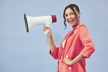 Photo for Portrait, megaphone and woman with a smile, announcement and speech on a blue studio background. Face, person or model with a gender equality, communication and bullhorn with news, noise and speaking. - Royalty Free Image
