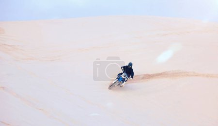 Photo for Fast, sand or driver driving motorbike for action, adventure or fitness with performance or adrenaline. Nature, dirt or sports athlete on motorcycle on dunes in training, exercise or race challenge. - Royalty Free Image