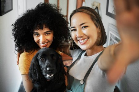 Photo for Smile, selfie and portrait of lesbian couple with dog in modern apartment bonding together. Love, happy and interracial young lgbtq women taking a picture and holding animal pet puppy at home - Royalty Free Image