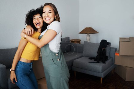 Photo for Lesbian, couple and hug for moving, home and dog in living room with excited, happiness and investment in apartment or property. Happy, people and women together with pet in celebration of new house. - Royalty Free Image