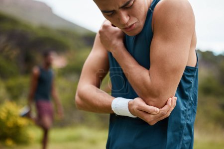 Sports man, nature and elbow pain from workout training injury or fitness running accident outdoors. Bad bruise, broken arm bone or closeup of injured athlete runner with exercise emergency in park.