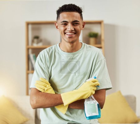 Photo for Cleaner, man in portrait and chemical with arms crossed, happy and hygiene with housekeeping, detergent and gloves. Janitor, cleaning solution in bottle with smile and professional housekeeper. - Royalty Free Image