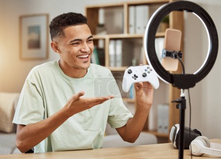 Photo for Man, live streaming for gaming and social media influencer, .smartphone filming tech review, online gamer with controller. Video game promo, streamer with ring light for content creation and feedback. - Royalty Free Image