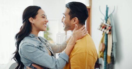 Photo for Couple, happy and hug in home lounge with a smile, security and love in healthy relationship. Young man and woman together in an apartment for affection, forehead touch and communication with care. - Royalty Free Image